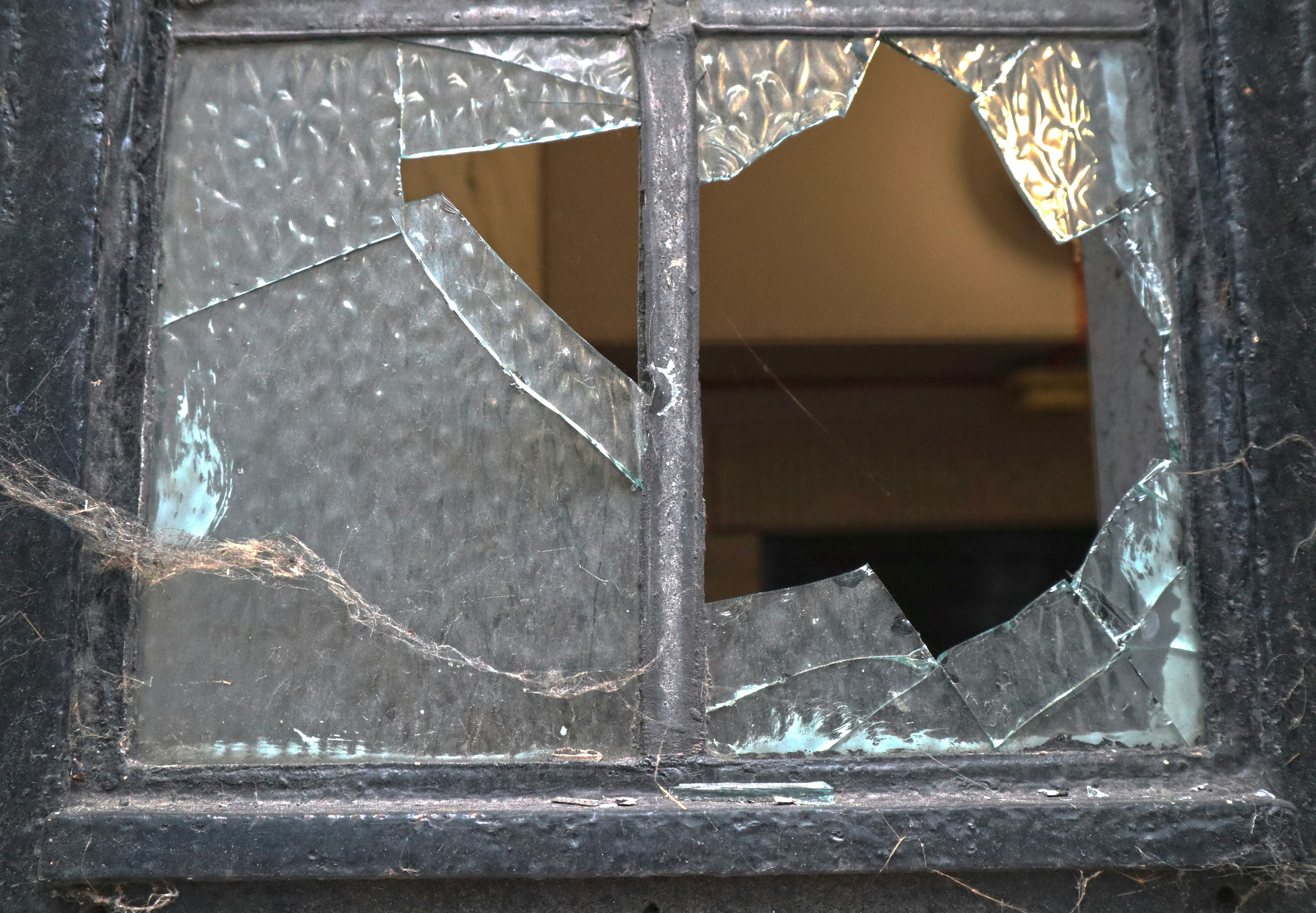 A historic six-over-six wood sash window on an older Denver home, looking out over the city